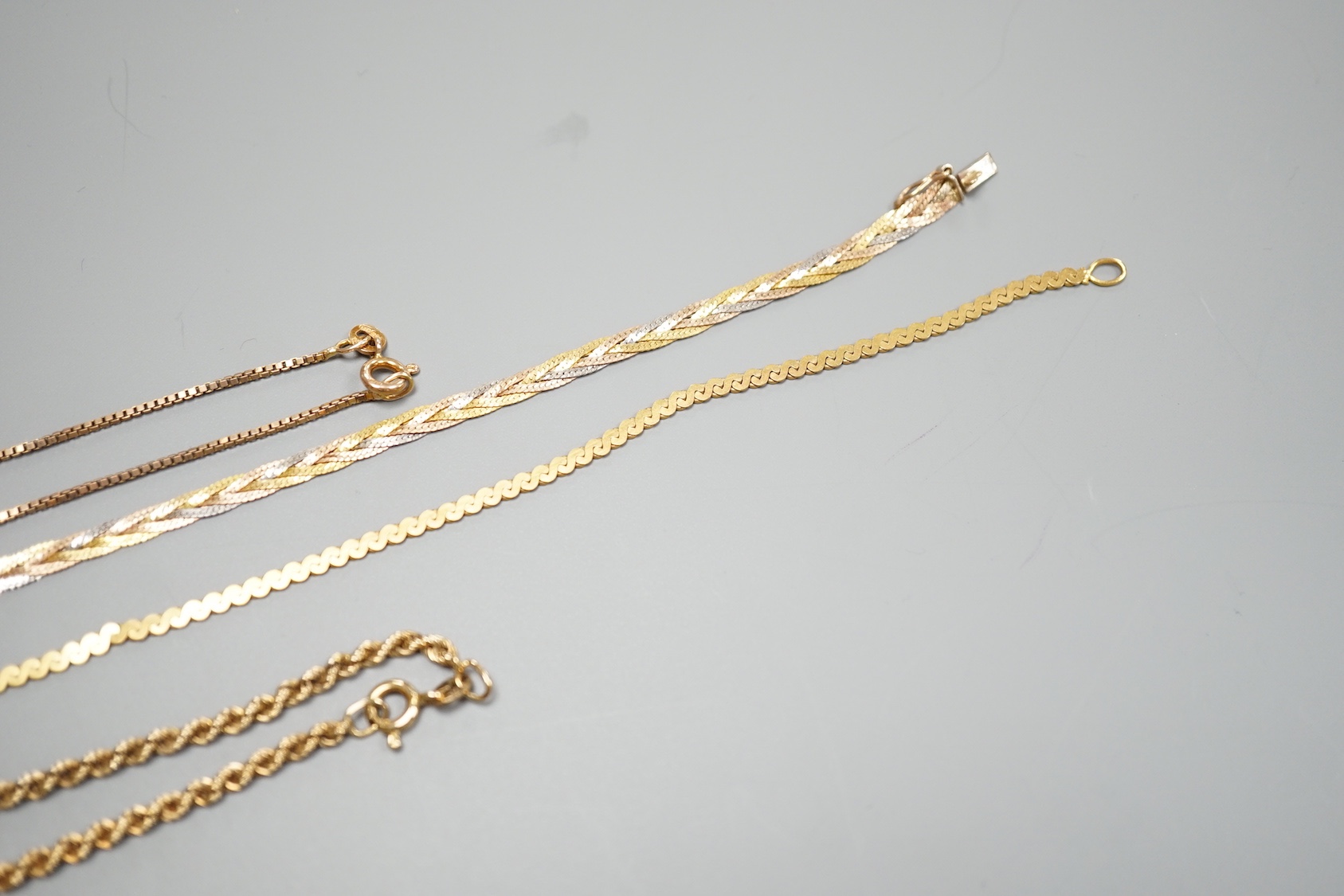 Four assorted modern 9ct chains, including three colour and rope twist, largest 38cm, 25.1 grams.